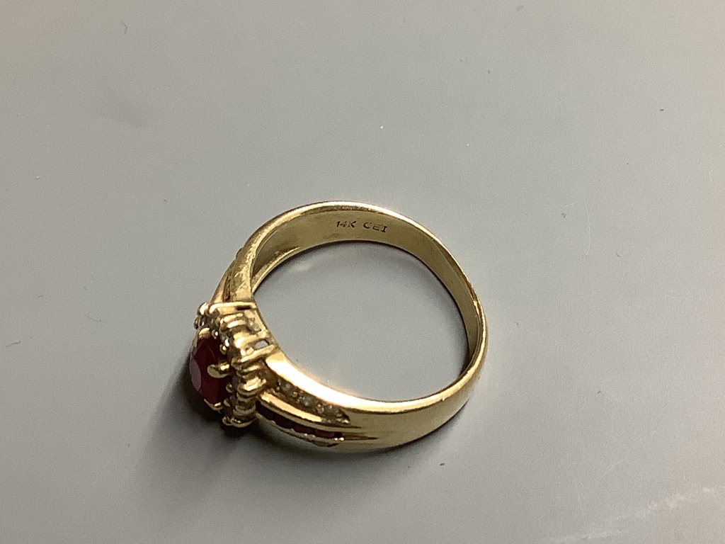 A modern 14 K yellow metal, ruby and diamond cluster ring, size M, gross 3.9 g.